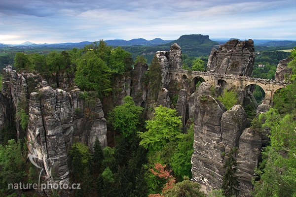 Most Basteibrücke z vyhlídky u Bastei, Fotografie: Most Basteibrücke, vyhlídka Bastei, Autor: Ondřej Prosický, Model aparátu: Canon EOS 20D, Objektiv: Canon EF 17-40mm f/4 L USM + polarizační filtr, Použité ohnisko (EQ35mm): 27 mm, stativ: Gizto 1227LVL + 1377M, Clona: 14.0, Čas: 2.0 s, ISO: 100, Měření expozice: celoplošné, Korekce expozice 0 EV, Blesk: ne, Vytvořeno: 29. dubna 2006, 6:45, most Basteibrücke, Bastei, Saské Švýcarsko (Německo)
